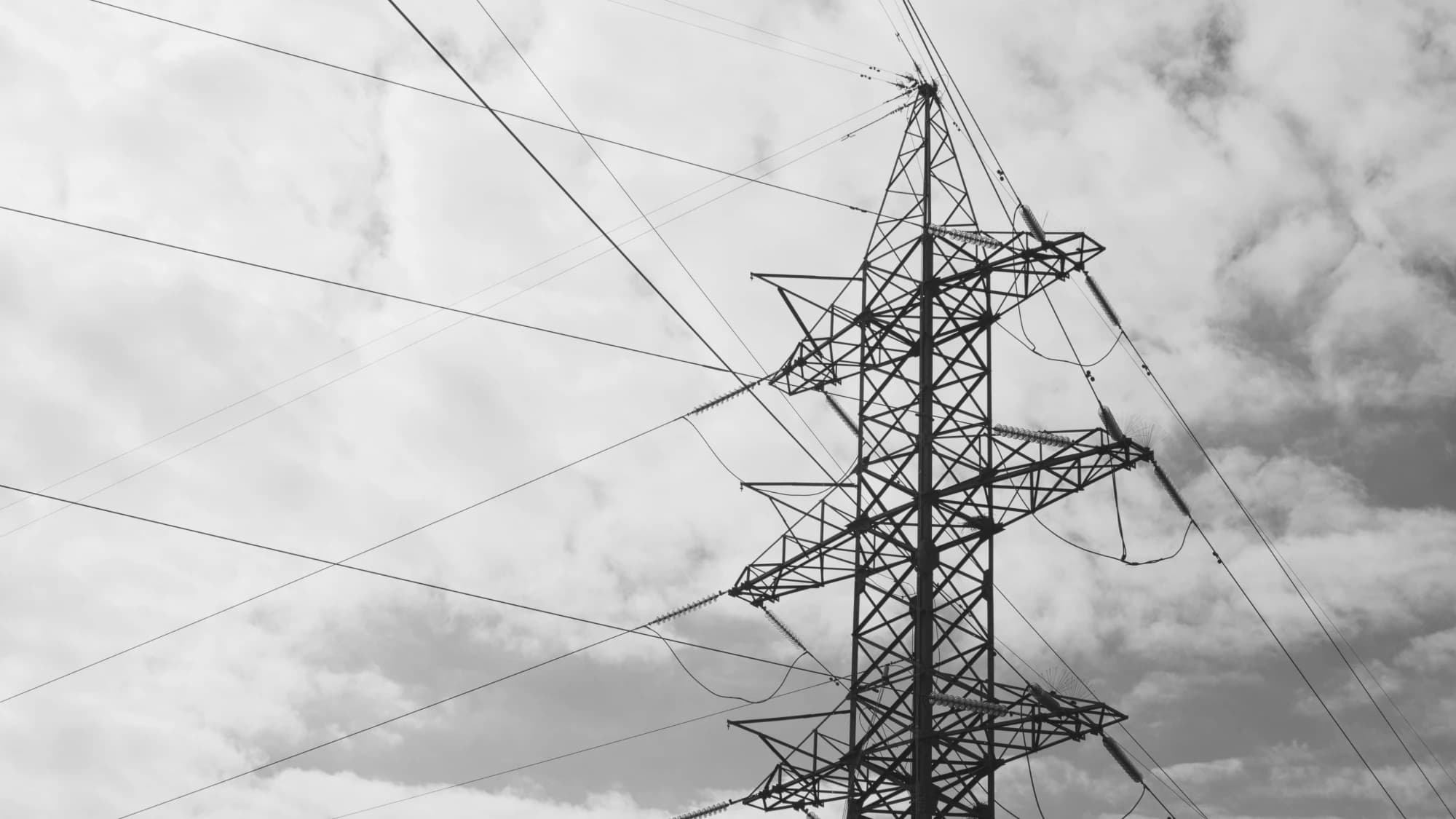 High-voltage transmission tower and lines, monochrome
