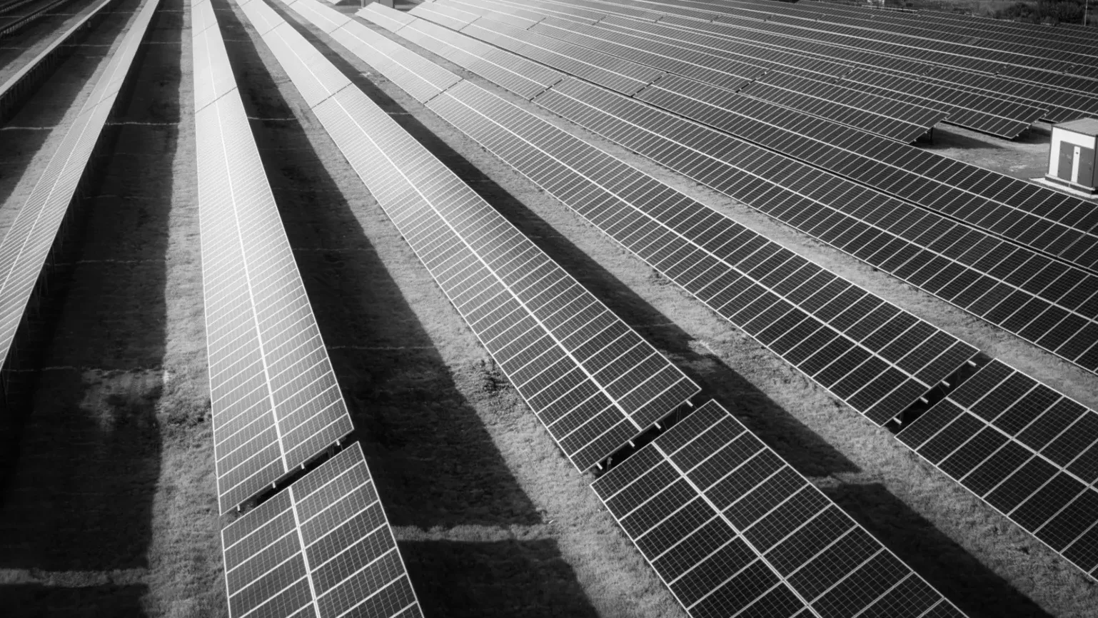 Aerial view of a utility-scale solar array on open land
